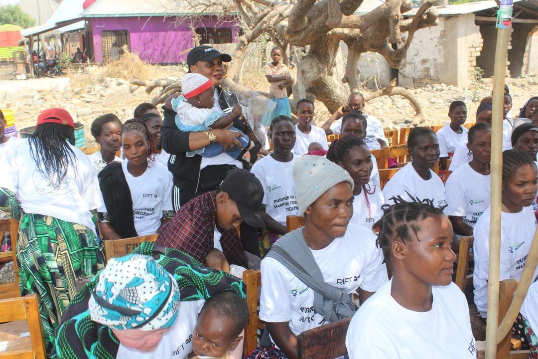 Vivian Sirikwa holding a participant's baby at the Ivuna launch